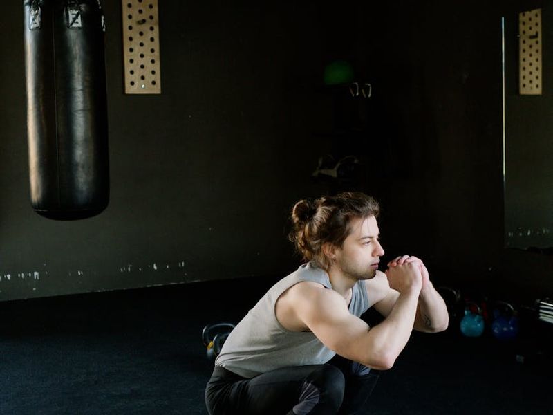 Man performing a controlled bodyweight squat with perfect form.